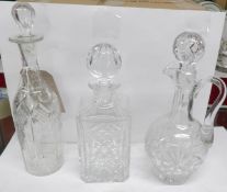 2 fine cut glass decanters and an early 20th century wine carafe