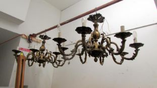 A pair of ornate 7 lamp ceiling lights