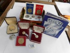 A tin of coins including £5, crown,