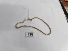 A yellow metal Albert watch chain