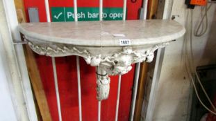 A marble top console table on metal base
