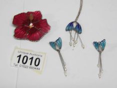 An enamel pendant and matching earrings together with an enamel flower brooch