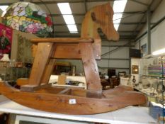 A polished pine rocking horse