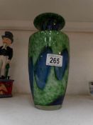 A green and blue art glass vase