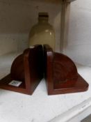 A pair of wooden book ends and a stone ware hot water bottle