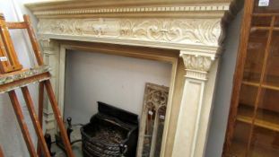 A large painted fire surround complete with grate