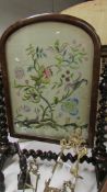 A superb Victorian fire screen with silk embroidered panel,