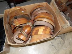 A box of turned wood bowls and a table lamp