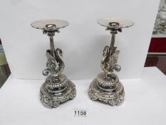 A pair of fine Elkington silver plate candlesticks surmounted swans