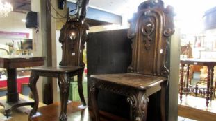 A pair of Victorian Gothic style hall chairs