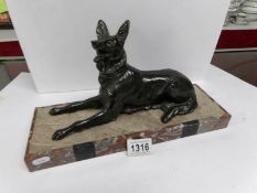 A bronze alsation dog on base