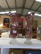 A pair of pink glass vases
