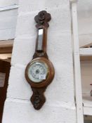 An Edwardian carved oak barometer