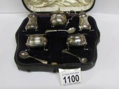 A cased silver cruet set (1 odd spoon),