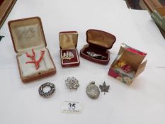 A mixed lot of brooches including some silver