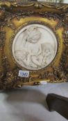 A gilt framed plaque of cherubs