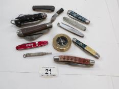 A mixed lot of pen knives and a brass compass