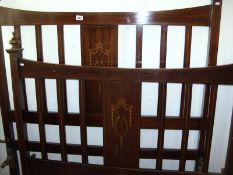 An Edwardian inlaid bedstead with side irons
