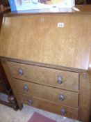 An oak veneered 3 drawer desk
