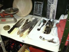 A shelf of cutlery, scales etc