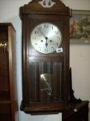 An Edwardian wall clock in working order