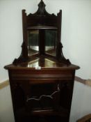 A Victorian mahogany corner cupboard