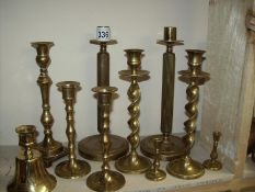 A quantity of old brass candlesticks