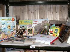 A shelf of books, pencils etc