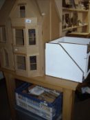 An unfinished dolls house and 2 boxes of accessories