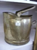 An old brass coal bin