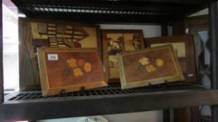 A shelf of inlaid pictures