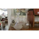 3 glass decanters and a glass oil lamp