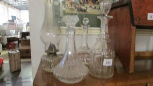 3 glass decanters and a glass oil lamp