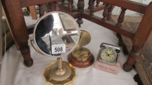 A shaving mirror, a compass and a travel clock