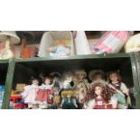 A limited edition baby doll and a shelf of collector's dolls