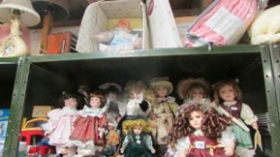 A limited edition baby doll and a shelf of collector's dolls