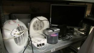 A shelf of electrical items including fan heaters