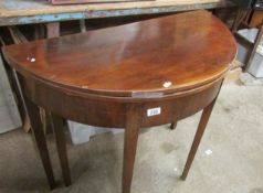 A mahogany fold over table