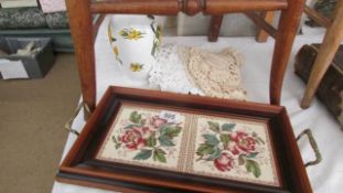A tiled tray, vase and doilies