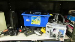 A Sony play station and accessories, one shelf