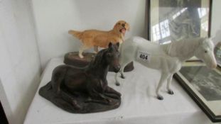 2 horse figures and a golden retriever