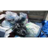 A large quantity of bags of clothes and curtains