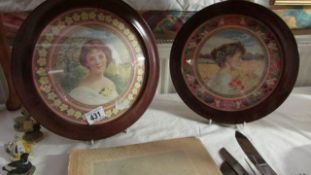 A pair of circular framed and glazed prints of young women