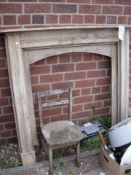 A pine fire surround and a chair