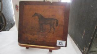 A hand painted wooden panel depicting a horse