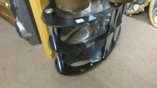 A 3 tier black glass coffee table
