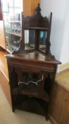 An Edwardian mahogany corner cupboard