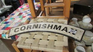 A curved cast iron 'Cornishman' sign