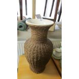 A wicker covered vase