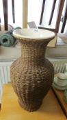 A wicker covered vase